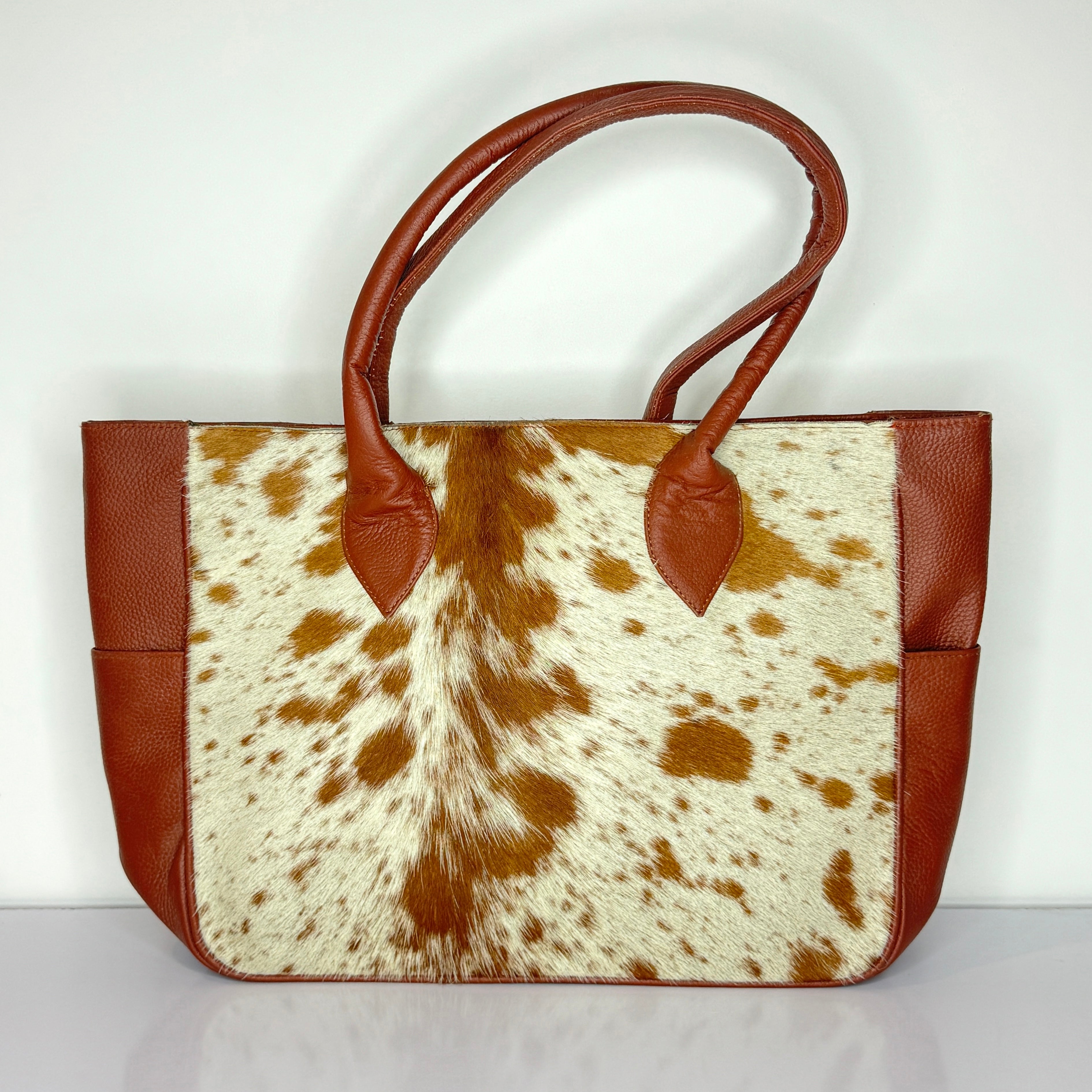 Tan And White Cowhide Leather Tote Bag with Tassel Accent