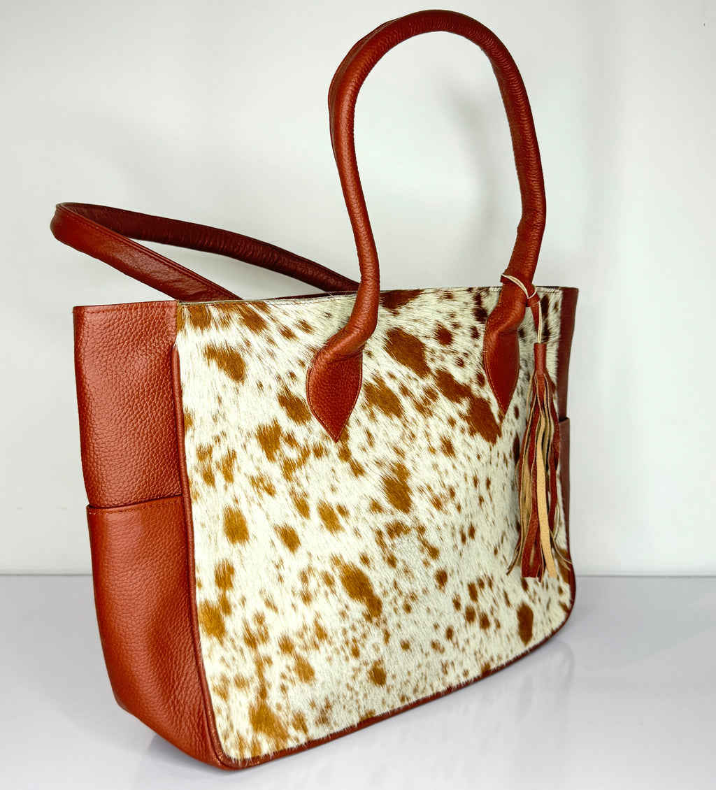 Tan And White Cowhide Leather Tote Bag with Tassel Accent