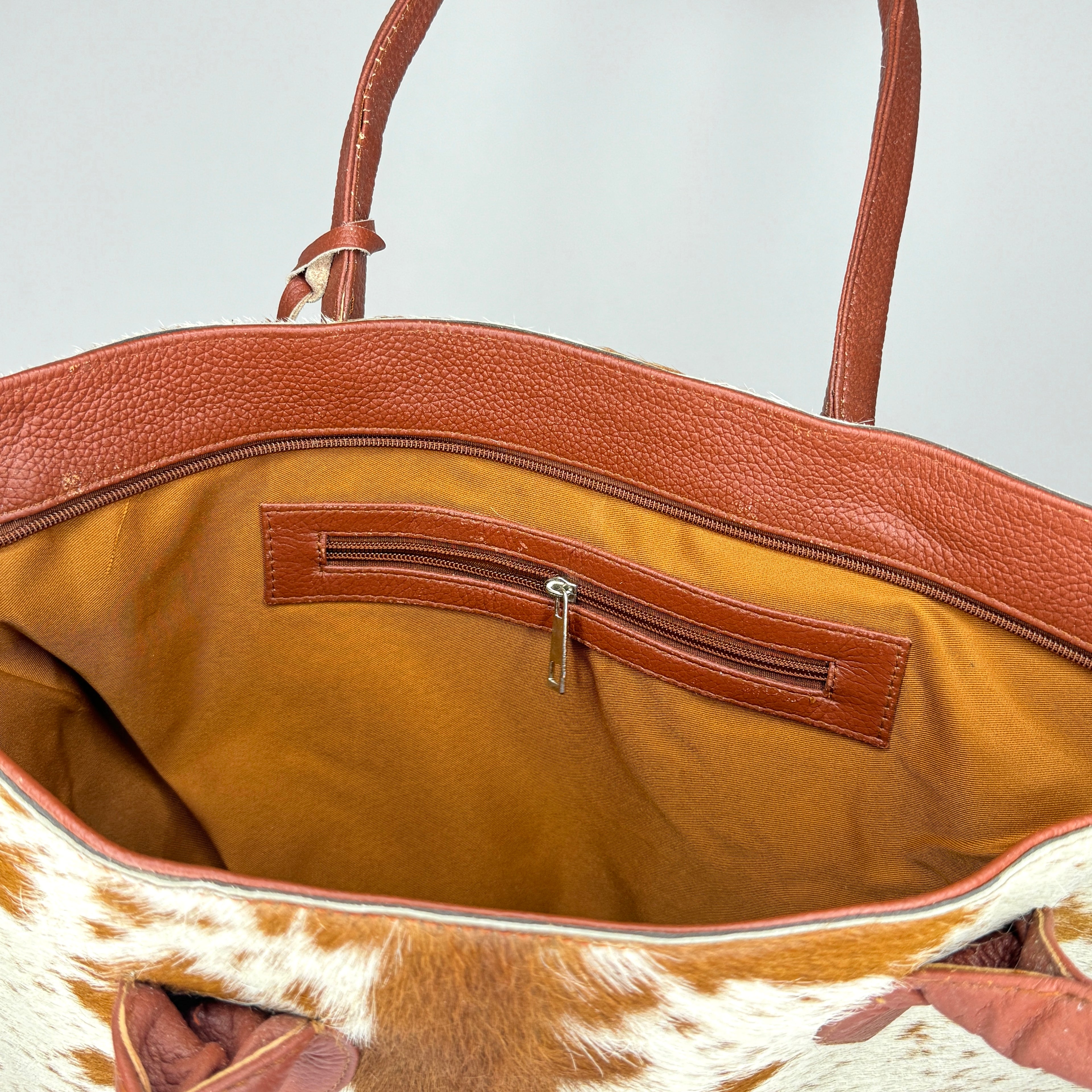 Tan And White Cowhide Leather Tote Bag with Tassel Accent