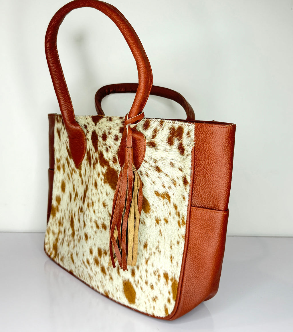 Tan And White Cowhide Leather Tote Bag with Tassel Accent