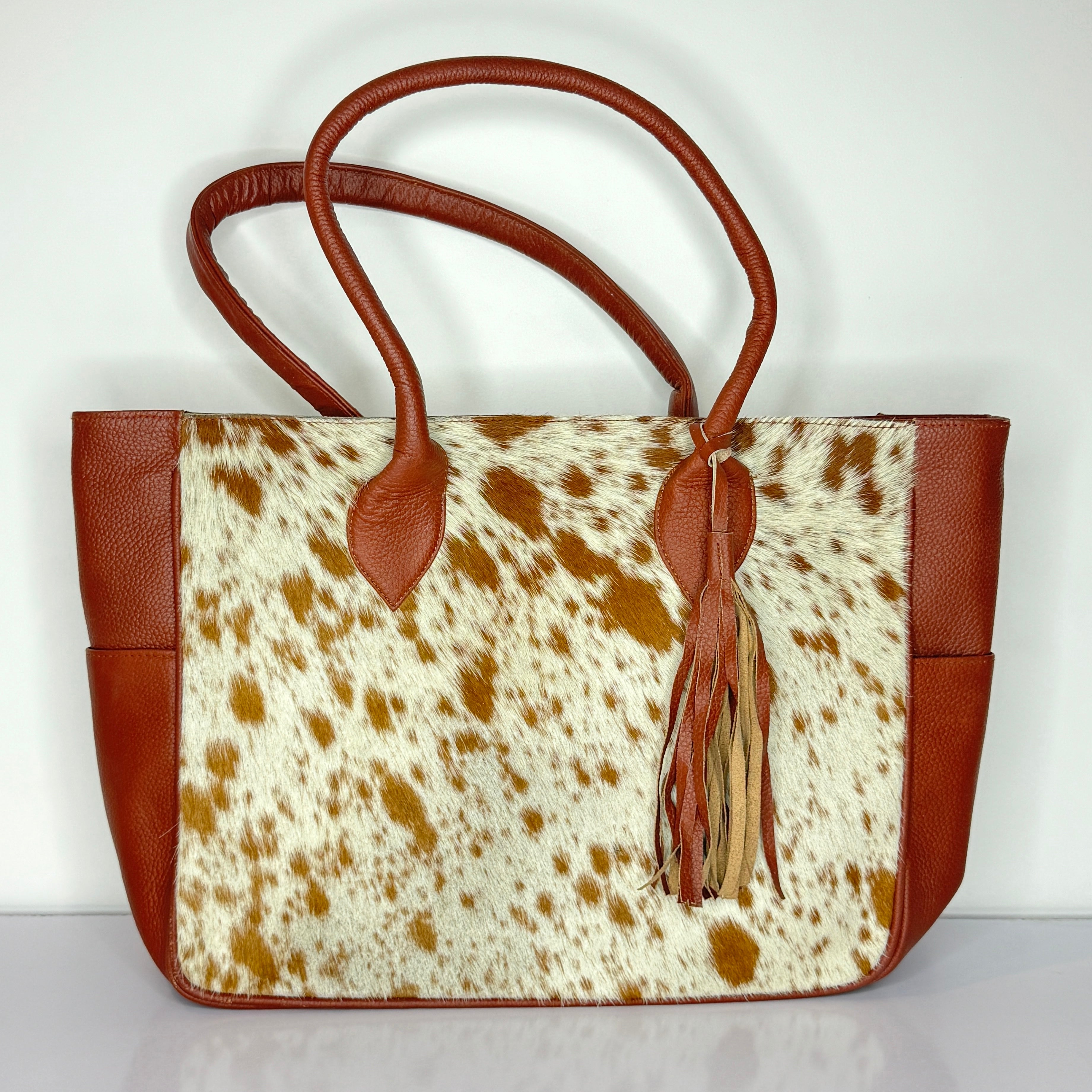 Tan And White Cowhide Leather Tote Bag with Tassel Accent